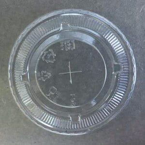 Clear plastic disposable cup lid with straw slot.